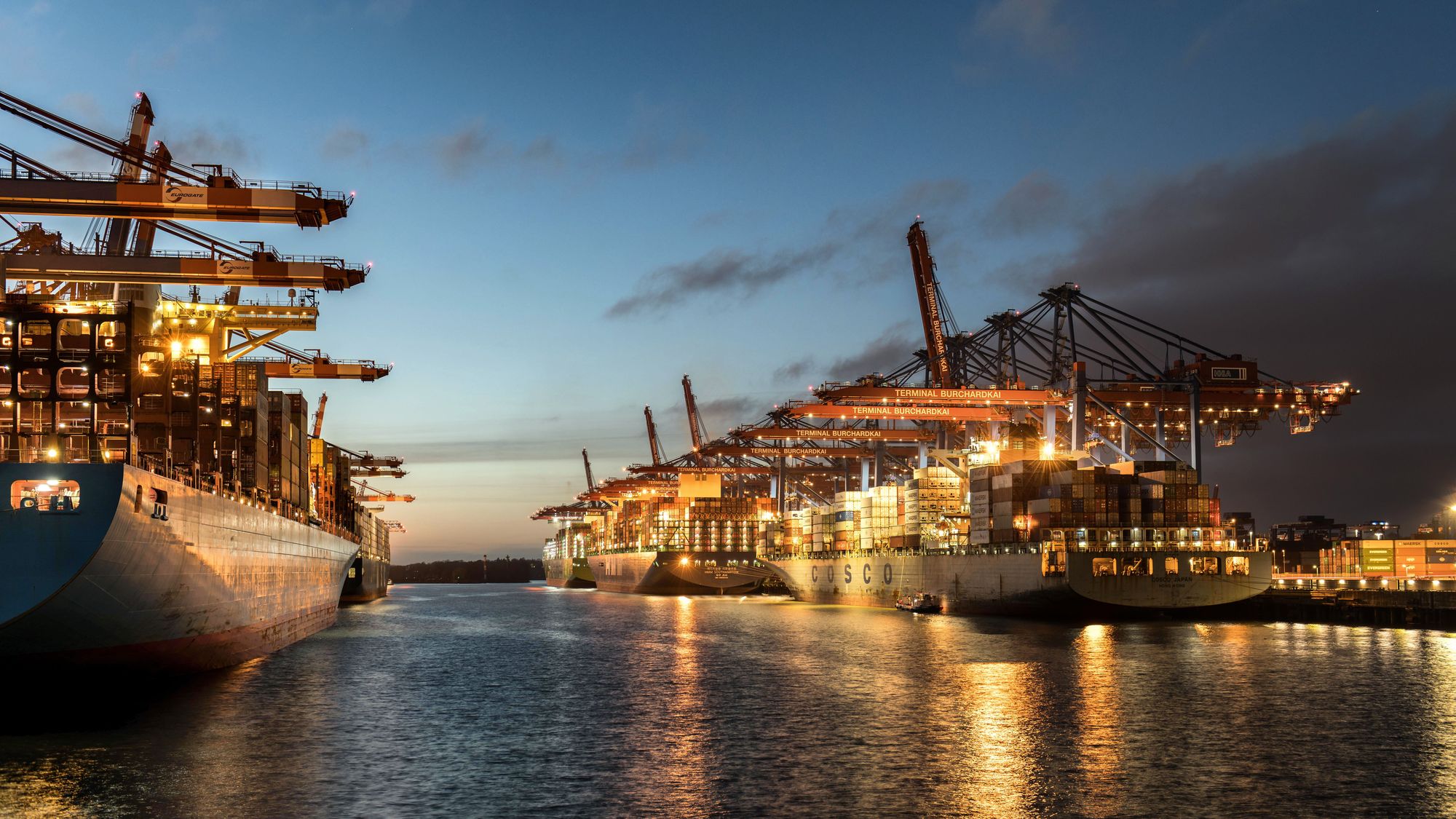 Container ships at a major port terminal at twilight